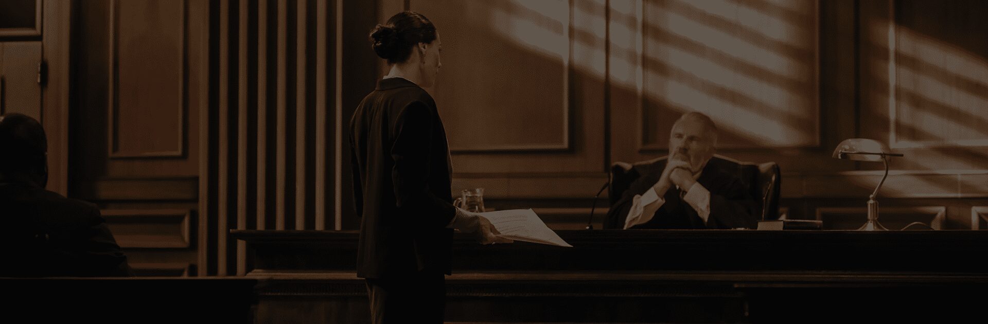 A woman standing in front of a piano.