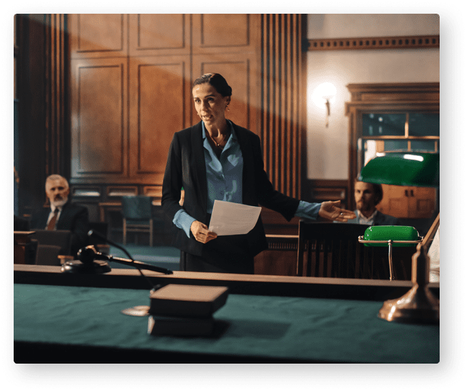 A woman standing in front of a table holding papers.