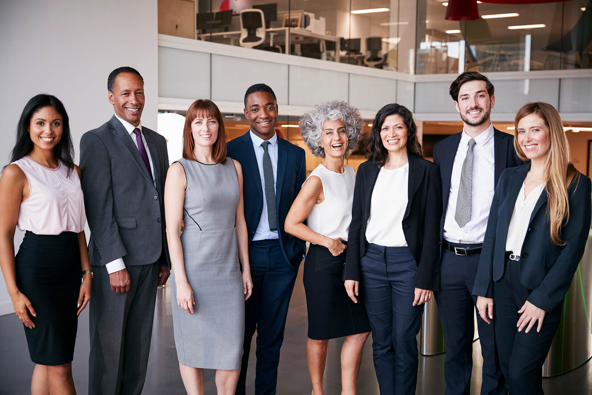 A group of people standing in front of an office building.