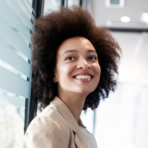 A woman with a big afro smiling for the camera.