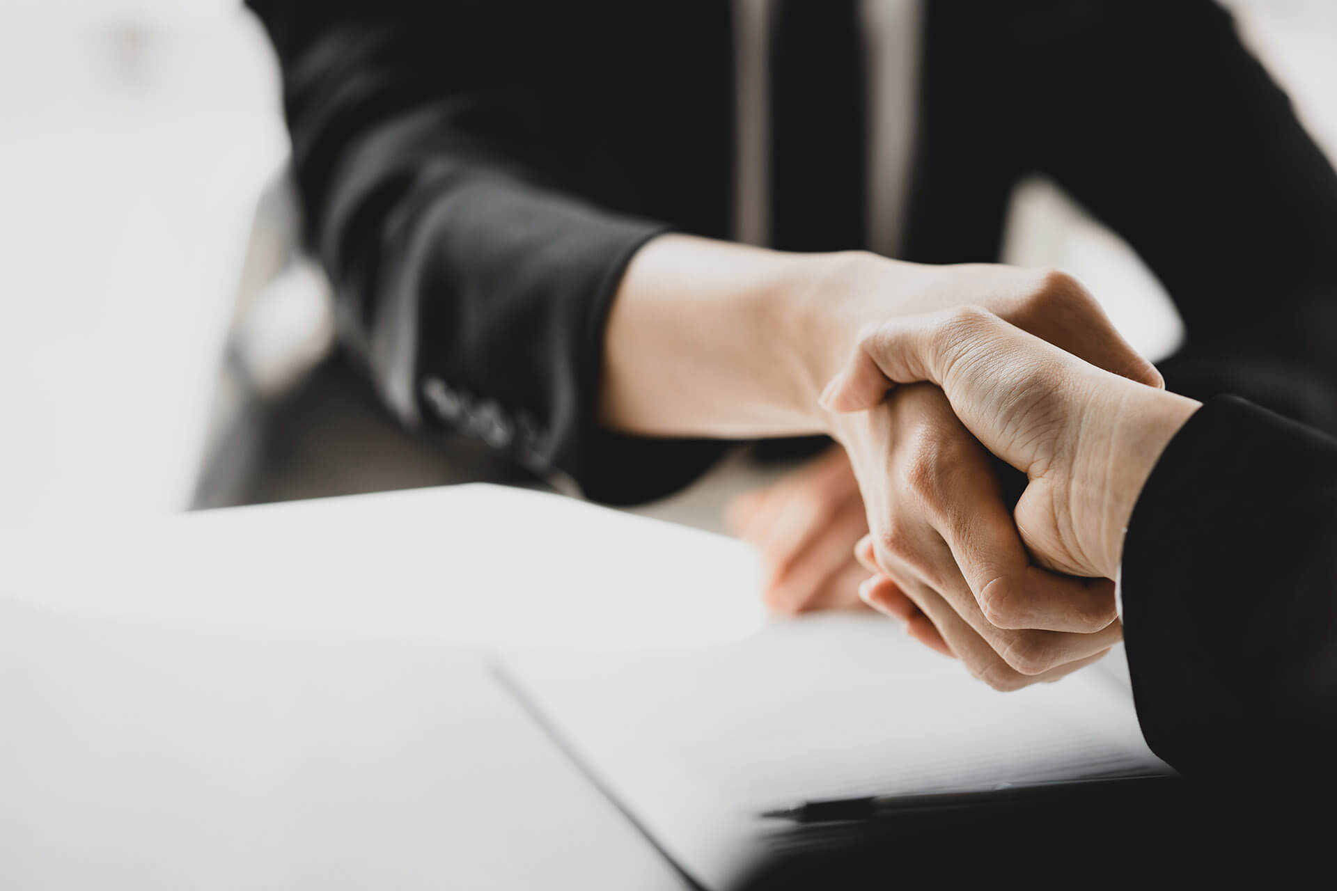 Two people holding hands over a table