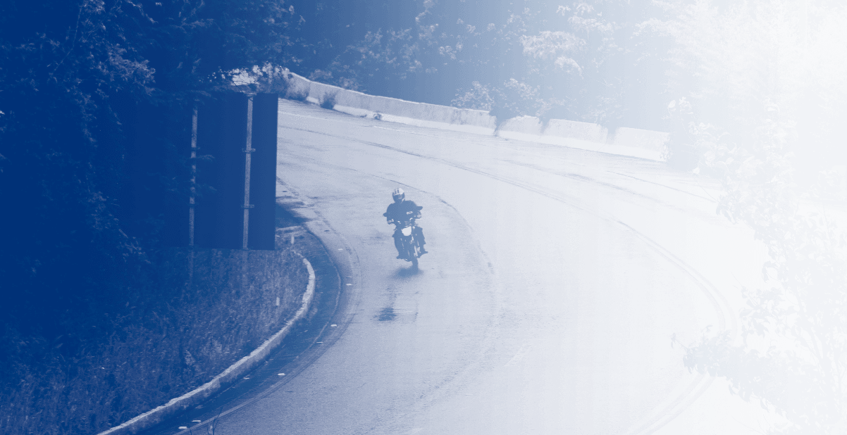 A person riding a motorcycle on top of snow covered ground.